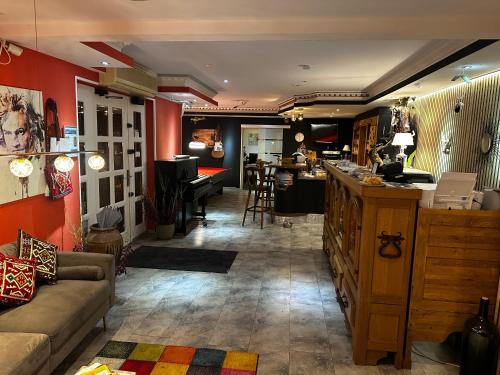 a living room with red walls and a couch and a bar at Green Seeblick Hotel am See in Obermaubach
