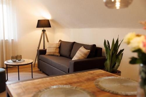 a living room with a couch and a table at VISTAMO Dorsten-Rhade, modernes Apartment in Dorsten