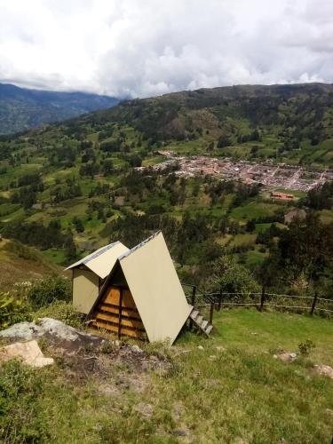 a small building on top of a grassy hill at Cabañas M L el cocuy Boyacá in El Cocuy