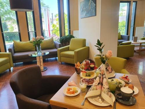 a table with food on it in a living room at Hotel Heffterhof in Salzburg