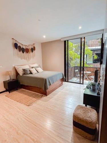 a bedroom with a bed and a wooden floor at New Loft! Jungle Gym Best Pool in Tulum