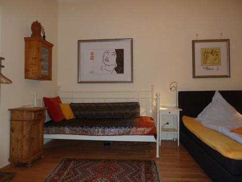a bedroom with a bed and a table and a bed sidx sidx sidx at Vorderer Westen Kassel in Kassel