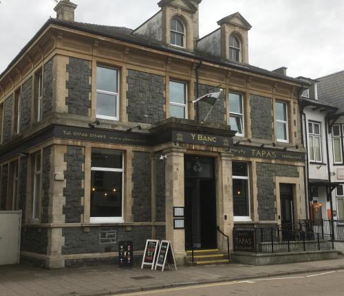 a large stone building with a sign in front of it at Banc Apartment 2 in Porthmadog