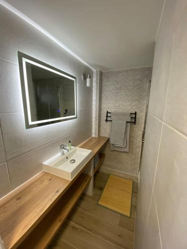 une salle de bain avec un lavabo et un miroir dans l'établissement Superbe appart rénové, vue mer, au Cap d'Agde
