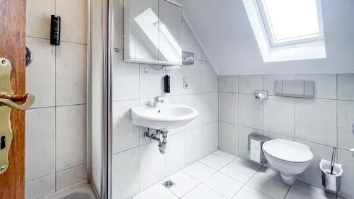 a white bathroom with a sink and a toilet at Smart Resorts B&B1 BB1 135 in Winterberg
