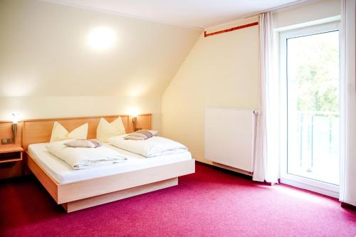 a bedroom with a white bed and a large window at Smart Resorts B&B1 BB1 131 in Winterberg