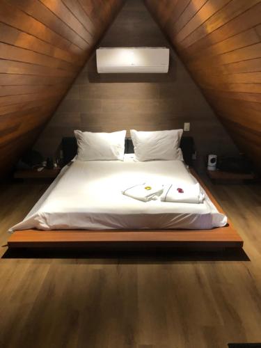 a bedroom with a bed in a attic at Eros lodge in Jaboticatubas