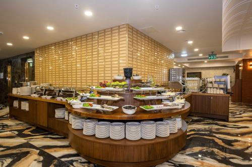 a buffet line with plates of food on display at Icon Hotel Bomonti in Istanbul