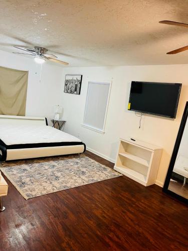 a bedroom with a bed and a flat screen tv at A place like nowhere else in Lawton