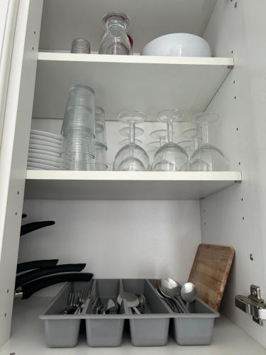 a kitchen filled with dishes and bowls on shelves at La Calada in Lorgues
