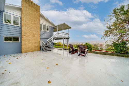 a patio with two chairs and a staircase on a house at Hot Tub and Sweeping Views Apt in Clarkston! in Clarkston