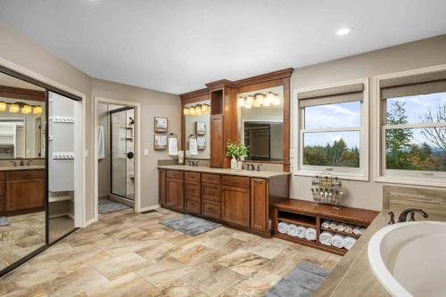 a large bathroom with a tub and a sink at Cooper Haven in Beaverton