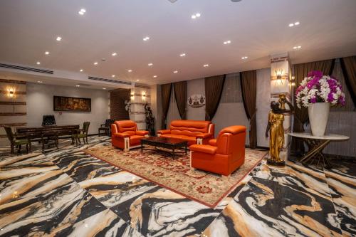 a hotel lobby with orange chairs and a table at Icon Hotel Bomonti in Istanbul