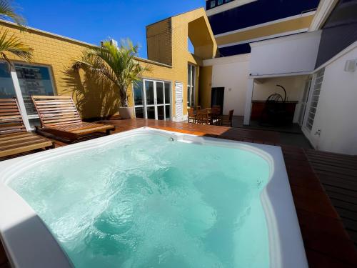 a swimming pool in front of a house at Hotel Euro Suite Campinas by Nacional Inn - Próximo ao Cambuí in Campinas