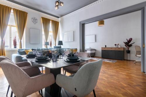 a living room with a dining table and chairs at 3 Bedroom - Central Superior-Flat 115m2 in Prague