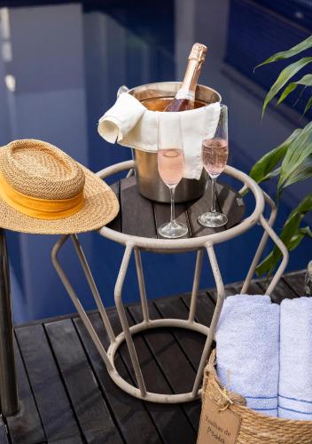 a table with a bottle of wine and two glasses at Tropikalya Gold Hotel in Balneário Camboriú