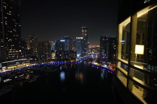 a view of a city at night with a river at 2 Bedroom Apartment full Marina View in Dubai