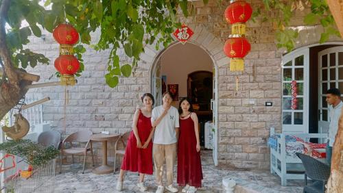 three women standing in front of a building with red lanterns at Dream Garden Luxor in Luxor