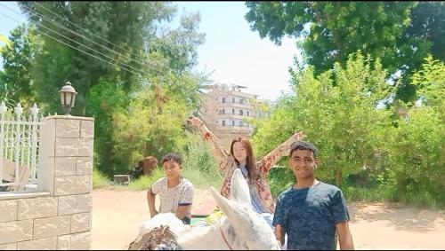 a woman and two children riding a horse at Dream Garden Luxor in Luxor