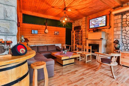 a living room with a couch and a fireplace at Elite Apartments in Kolašin