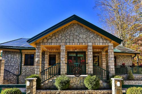 a small house with a stone exterior at Elite Apartments in Kolašin