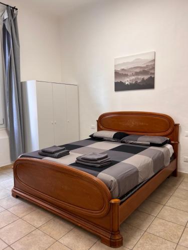 a bedroom with a wooden bed in a room at Affittacamere Da Pippi in Castel San Pietro Terme
