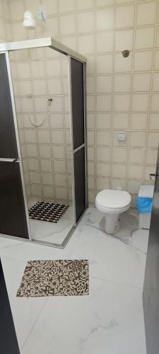 a bathroom with a shower and a toilet at 11Suites casa Suite #5 in Caraguatatuba