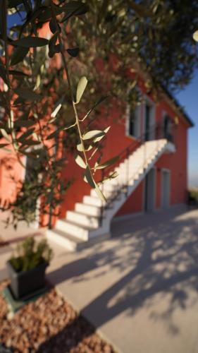 a red building with stairs in front of a building at Relais la Terrazza in Bussolengo