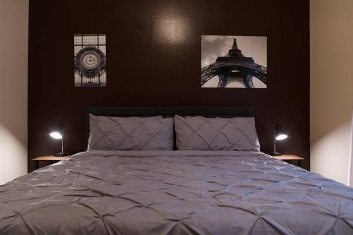 a bedroom with a bed and the eiffel tower at Gated townhouse with 2 suites, heated pool, hot tub in Mesa