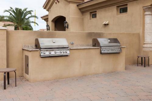 two burners on the side of a building with at Gated townhouse with 2 suites, heated pool, hot tub in Mesa