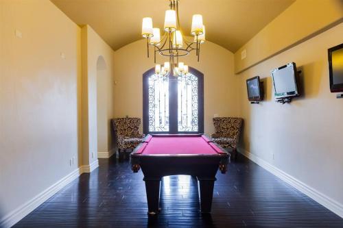 a room with a ping pong table in the middle at Gated townhouse with 2 suites, heated pool, hot tub in Mesa