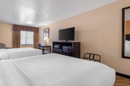 a hotel room with two beds and a flat screen tv at Best Western Campbellsville Inn in Campbellsville