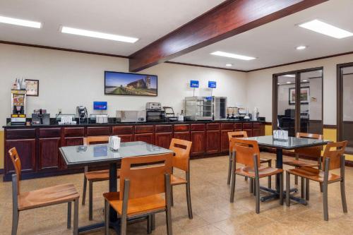 a restaurant with two tables and chairs and a counter at Best Western Campbellsville Inn in Campbellsville