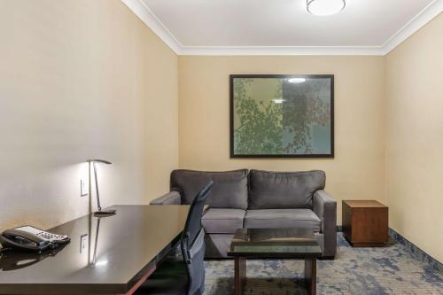 a living room with a couch and a table at Best Western PLUS Avita Suites in Torrance