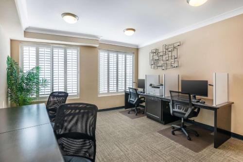 an office with a long table and chairs and a desk at Best Western PLUS Avita Suites in Torrance