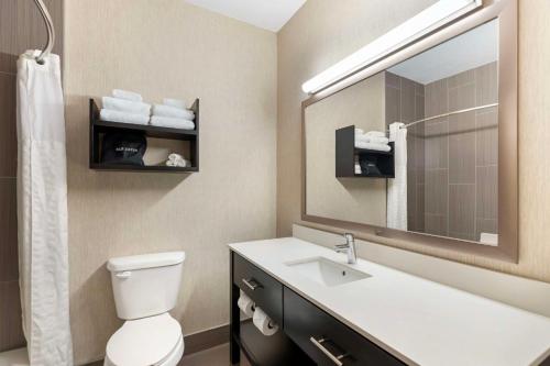 a bathroom with a sink and a mirror at Best Western Greeley in Greeley