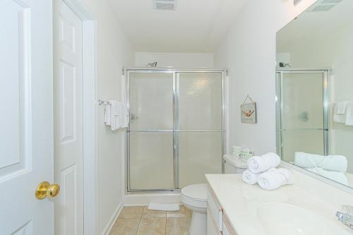 a white bathroom with a shower and a toilet at Stunning 3 Bedroom Condo-Recently Renovated-Fairways Unit D in Myrtle Beach