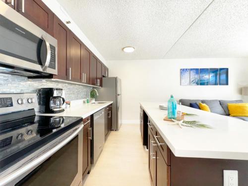 a kitchen with wooden cabinets and a counter top at Breathtaking Ocean View 1 BR Condo with Free Parking! in Honolulu
