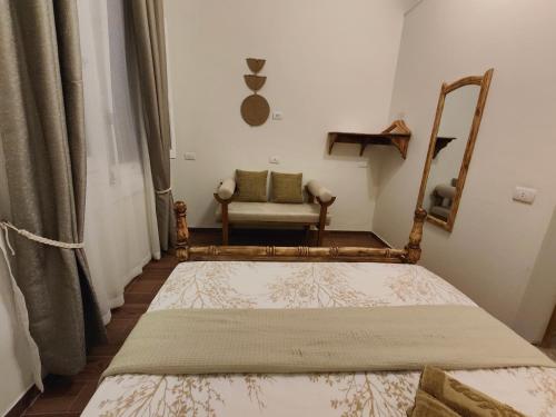 a bedroom with a bed and a chair in a room at Champollion Palace in Cairo
