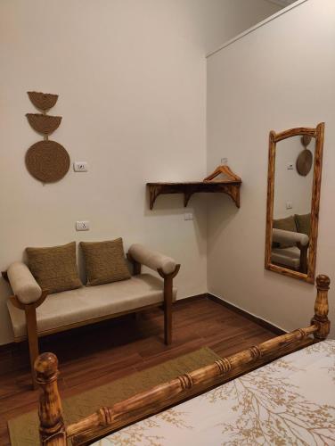 a living room with a couch and a mirror at Champollion Palace in Cairo