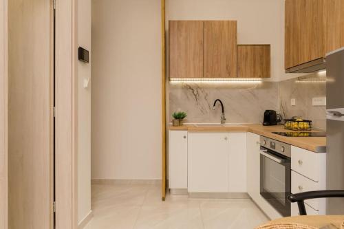 a kitchen with white cabinets and a sink at Melina's Suite in Zakynthos Town