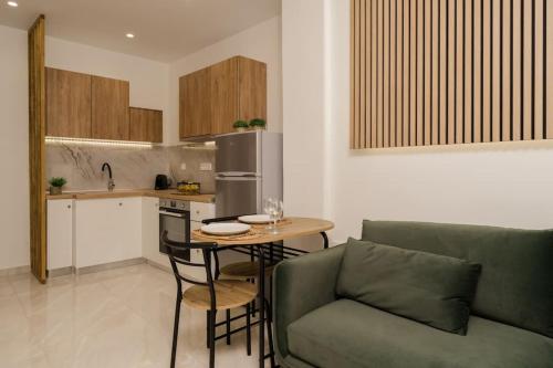 a living room with a couch and a table in a kitchen at Melina's Suite in Zakynthos Town