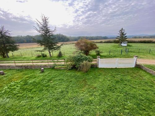 an aerial view of a field with a fence at Nid douillet au bord de l'eau in Saint-Just-Saint-Rambert