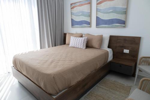 a bedroom with a large bed with a pillow on it at Ka' Romana Residences in El Soco