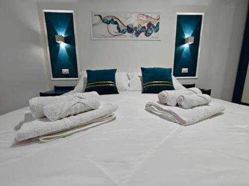 a bedroom with a white bed with towels on it at Profumo di casa in Lascari