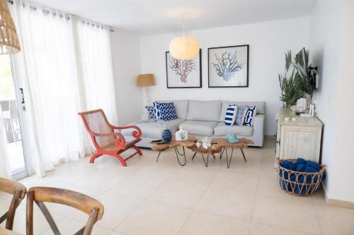 a living room with a couch and a table at Ka' Romana Residences in El Soco