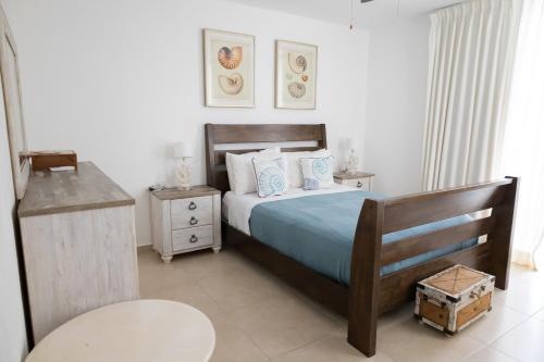 a bedroom with a bed with a wooden headboard at Ka' Romana Residences in El Soco