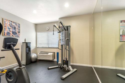 a fitness room with a gym with a treadmill at Best Western John Muir Inn in Martinez