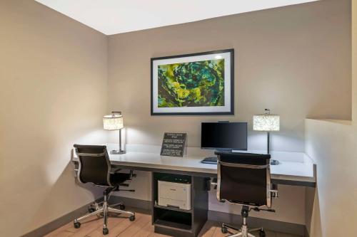 an office with a desk with a computer and two chairs at Best Western York Inn in York