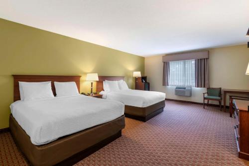 a hotel room with two beds and a television at Best Western York Inn in York